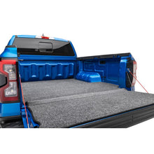 Load image into Gallery viewer, Husky Liners bed liner installed in a blue truck bed, rear tailgate-down view