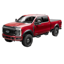 Load image into Gallery viewer, Rear view of Husky Liners RVL fender flares on Ford Super Duty highlighting extended mud flap design