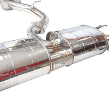 Load image into Gallery viewer, Close-up of the Invidia R400 dual muffler section showing hanger bracket and brand cutout logo