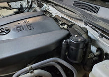 Load image into Gallery viewer, J&amp;L 16-23 Toyota Tacoma 3.5L Driver Side Oil Separator 3.0 - Black Anodized - Black Ops Auto Works