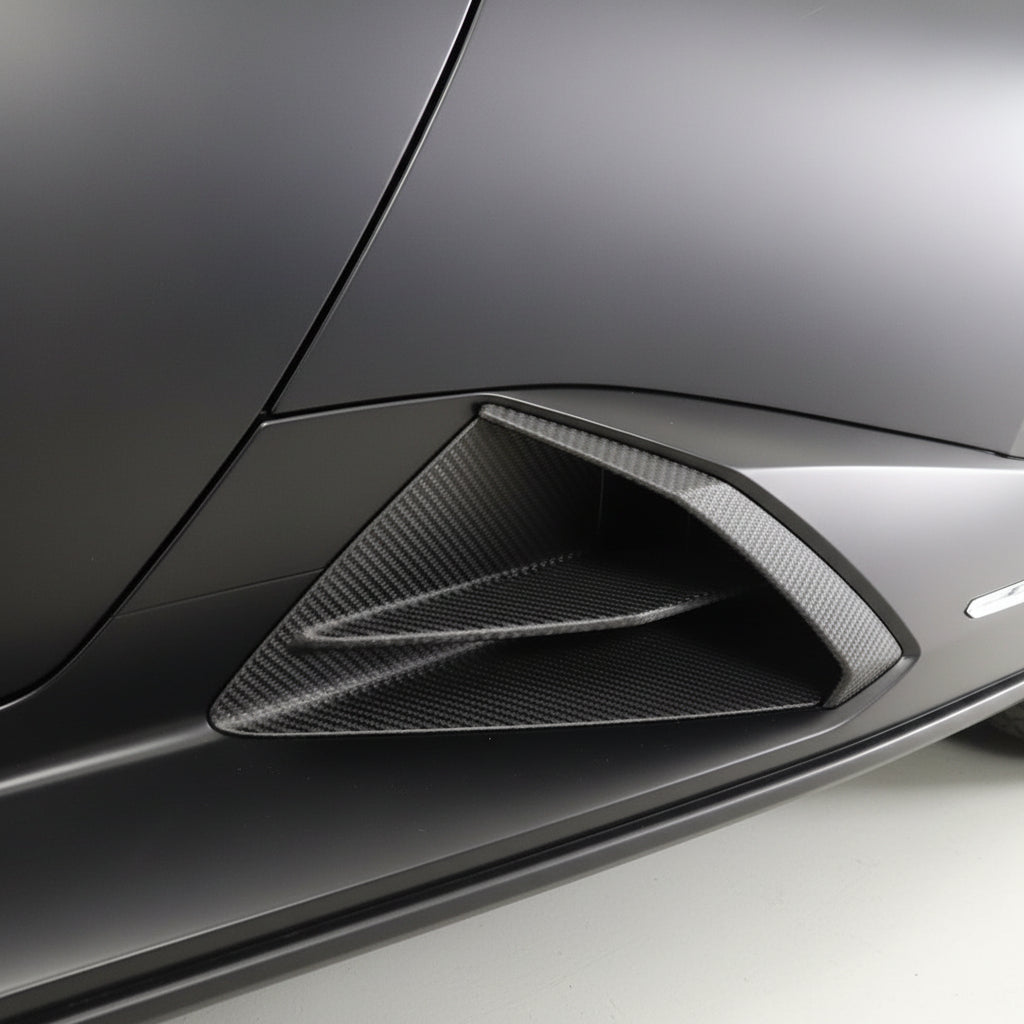 Factory OEM matte black plastic side skirt intake on a red Lamborghini Huracan