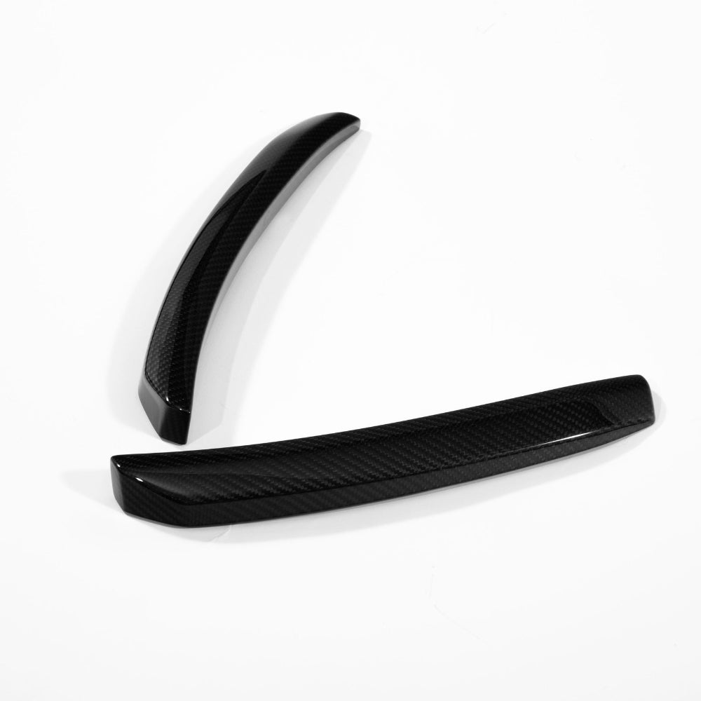Huracan STO carbon fiber wind deflector uprights in gloss twill, angled apart to show both curved faces