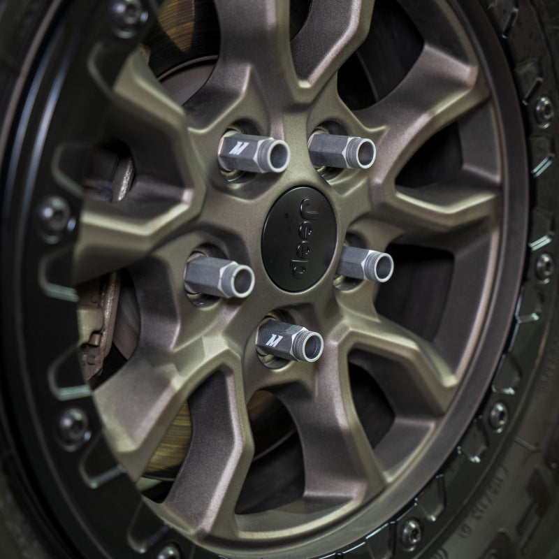 Mishimoto locking lug nuts installed on a bronze Jeep wheel