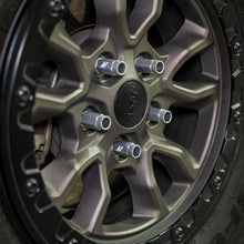 Load image into Gallery viewer, Mishimoto locking lug nuts installed on a bronze Jeep wheel