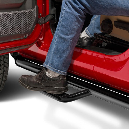 Person stepping out of a red Jeep Wrangler JL using the N-Fab nerf step