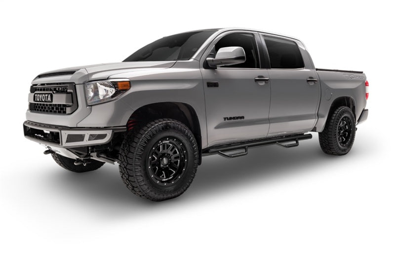Silver crew cab pickup with N-Fab nerf steps installed, front three-quarter view