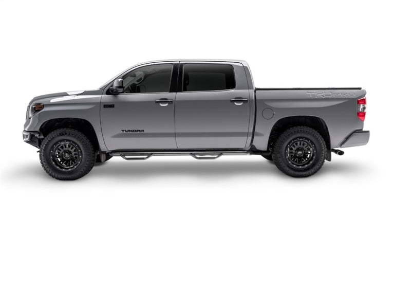 Silver crew cab pickup with N-Fab nerf steps installed, side profile view
