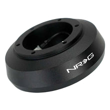 Load image into Gallery viewer, Black anodized NRG SRK-124H short hub adapter at an angle showing the bolt holes on the wheel mounting face