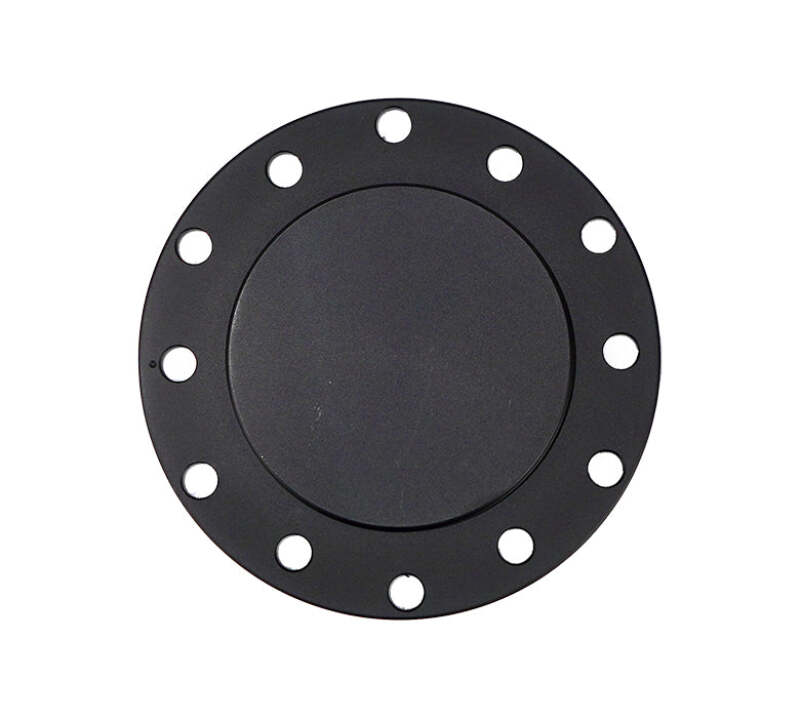 Black flush horn delete plate mounted on a steering wheel hub