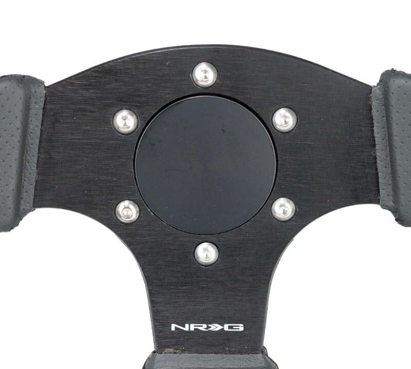 Close-up of black flush horn delete plate mounting holes and aluminum finish