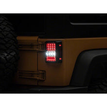 Load image into Gallery viewer, Raxiom 07-18 Jeep Wrangler JK Axial Series Lux LED Tail Lights- Black Housing (Clear Lens) - Raxiom J141596