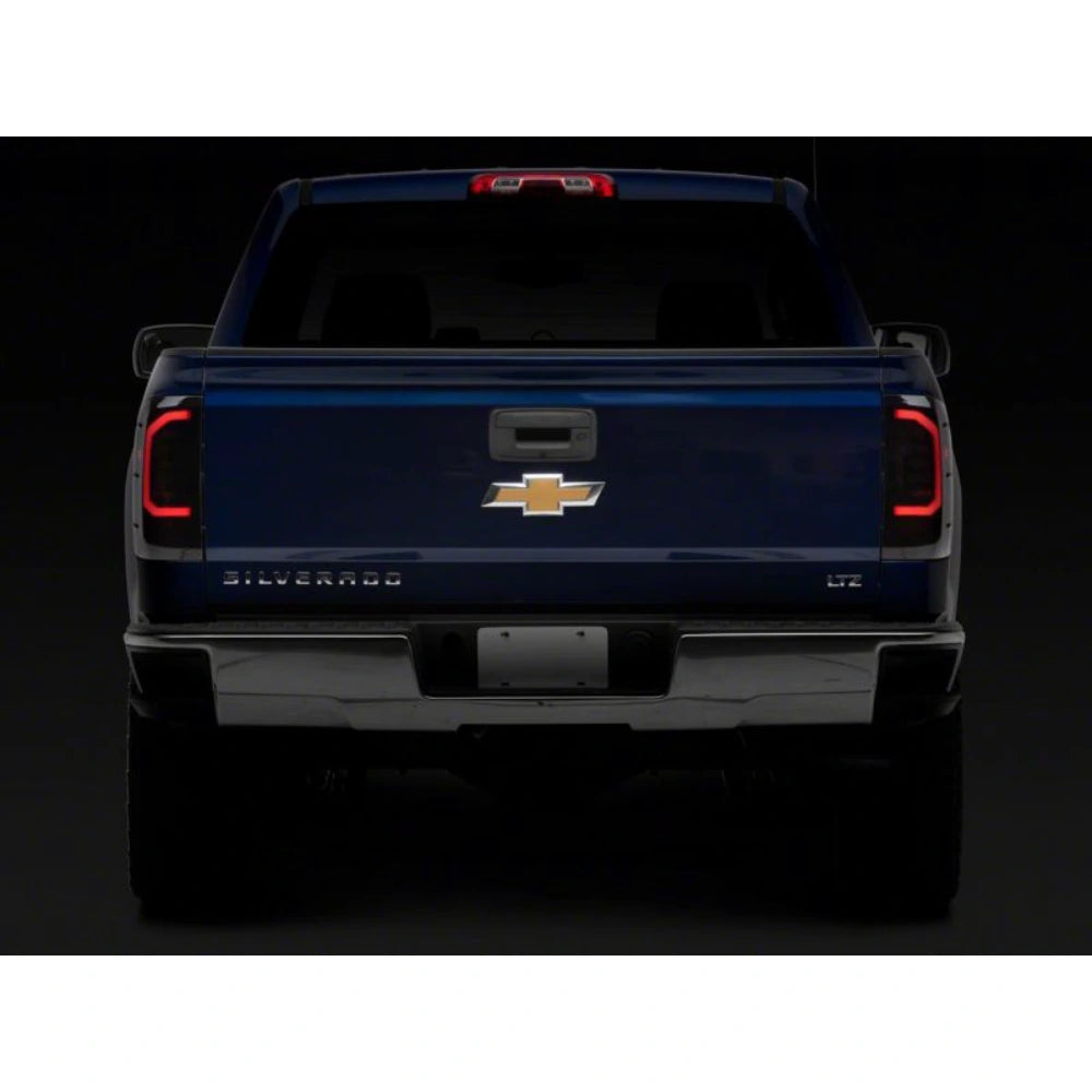 Raxiom 14-18 Chevrolet Silverado 1500 Axial Series LED Tail Lights- Black Housing (Smoked Lens) - Raxiom S151298