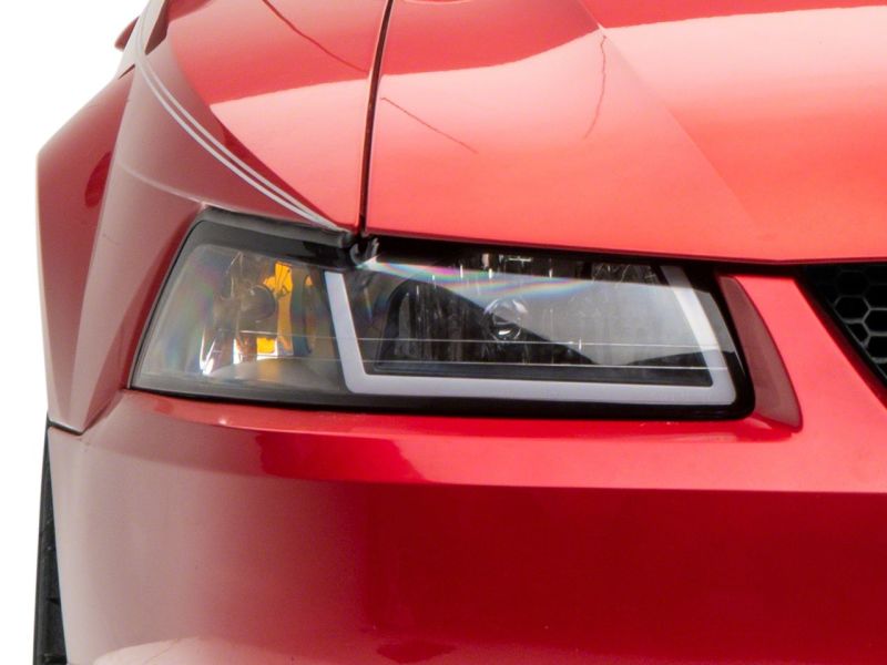 Raxiom Raxiom 99-04 Ford Mustang Axial Series Headlights w/ Sequential LED Bar- Black Housing (Clear Lens)
