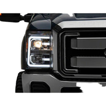 Load image into Gallery viewer, Close-up of a Ford Super Duty front corner with the Raxiom LED projector and accent bar illuminated
