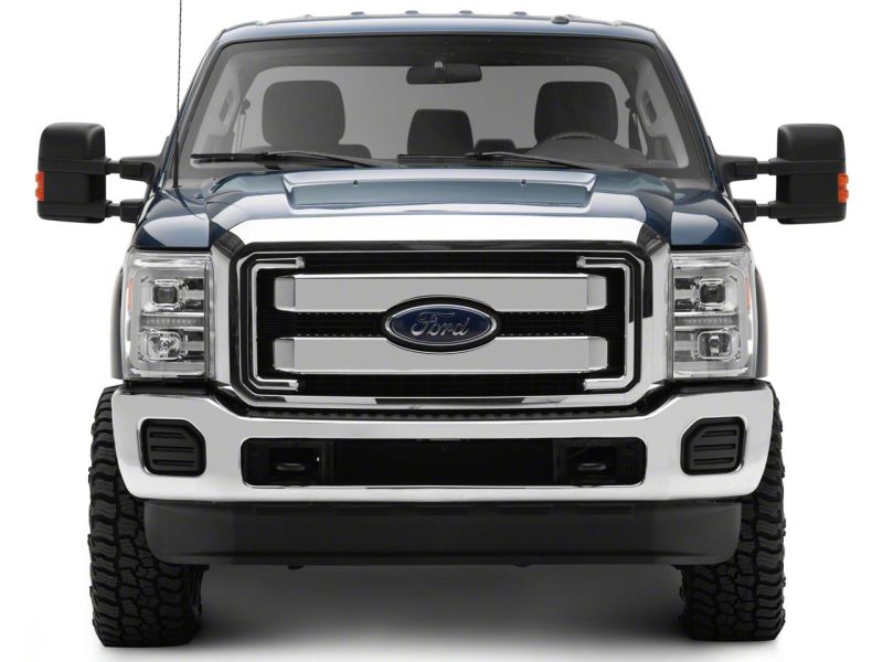 Blue Ford Super Duty photographed head on in daylight with the Raxiom LED projector headlights fitted