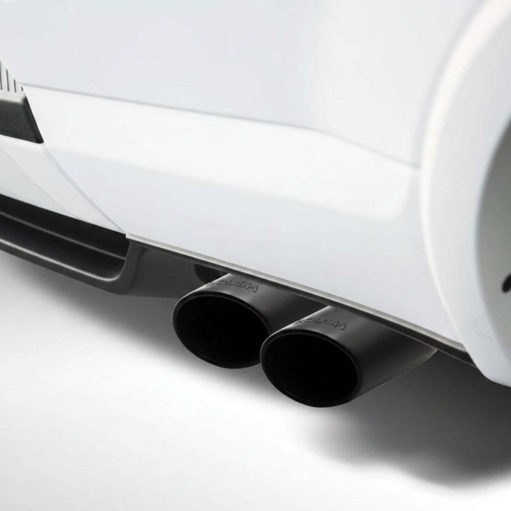 Roush 422318 4-inch black dual exhaust tips installed below a white 2015-2024 Ford F-150 5.0L rear bumper