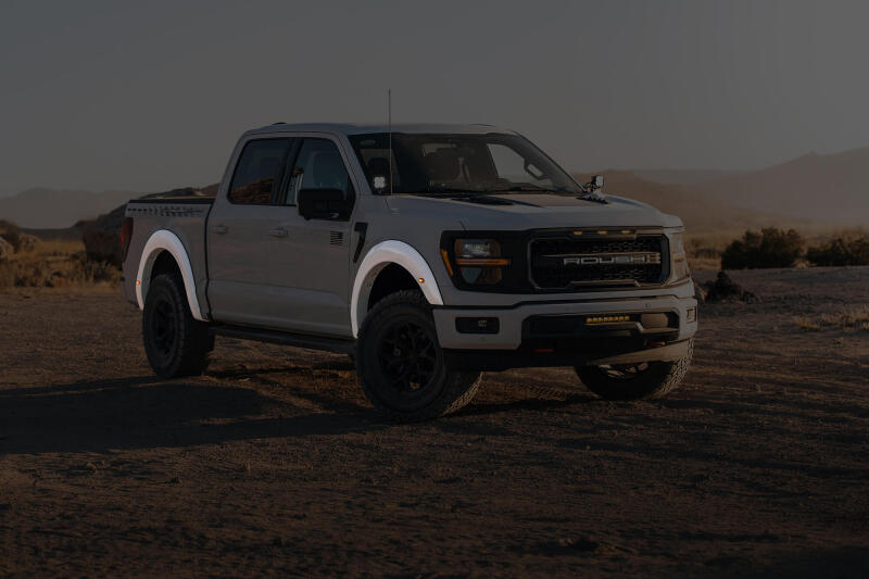 Roush 422332 primed fender flare kit for 2018-2024 Ford F-150, white truck shown outdoors with flares installed
