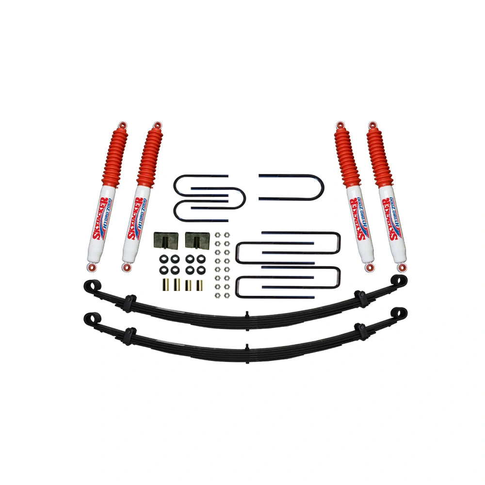 Skyjacker C240AK-H suspension lift kit components on white: leaf springs and mounting hardware, lift blocks and shocks