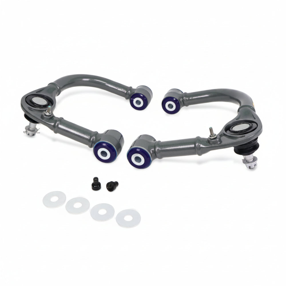 SuperPro front upper control arm pair, front view showing offset bushings and ball joint boots