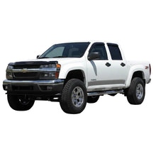 Load image into Gallery viewer, White lifted Chevy Colorado 4x4 with Tuff Country lift kit installed, front three-quarter view on a dirt road