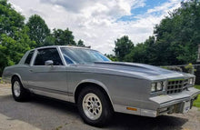 Load image into Gallery viewer, Angled view showing the profile of the pair of black powder coated front G-Body lowering springs.