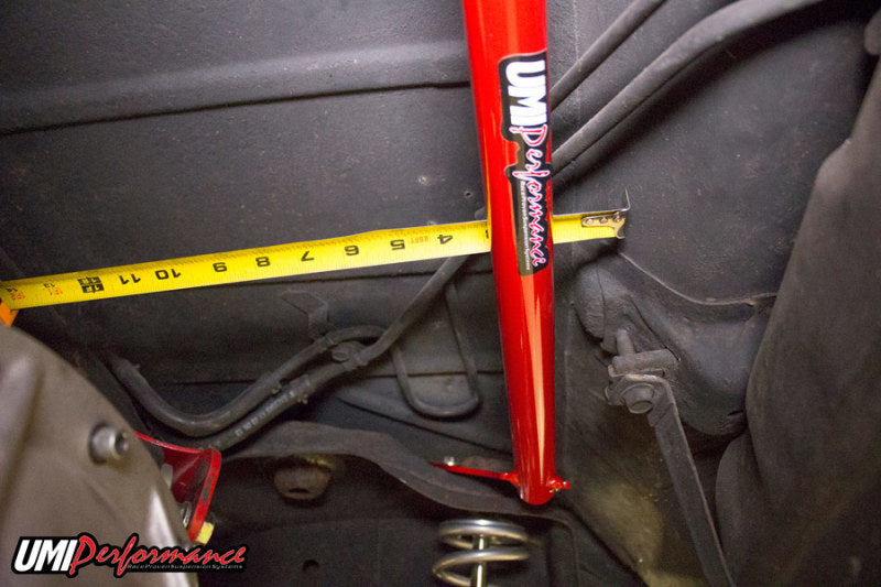 Angled view showing the profile of the bright red bolt-in rear shock tower brace.