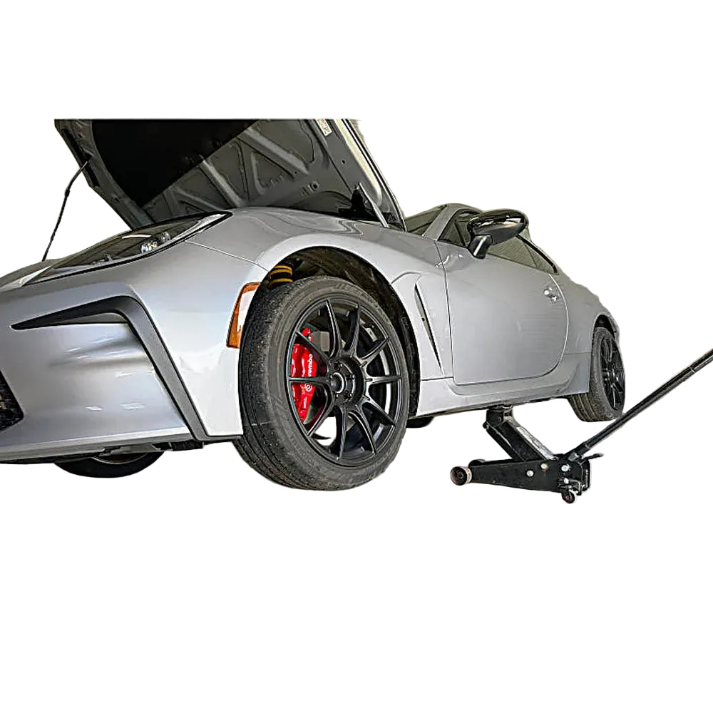 PERRIN jack pad in use on vehicle in garage