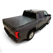 Load image into Gallery viewer, Rear view of a Toyota Tundra with the Westin 19-20285 cover partially folded.