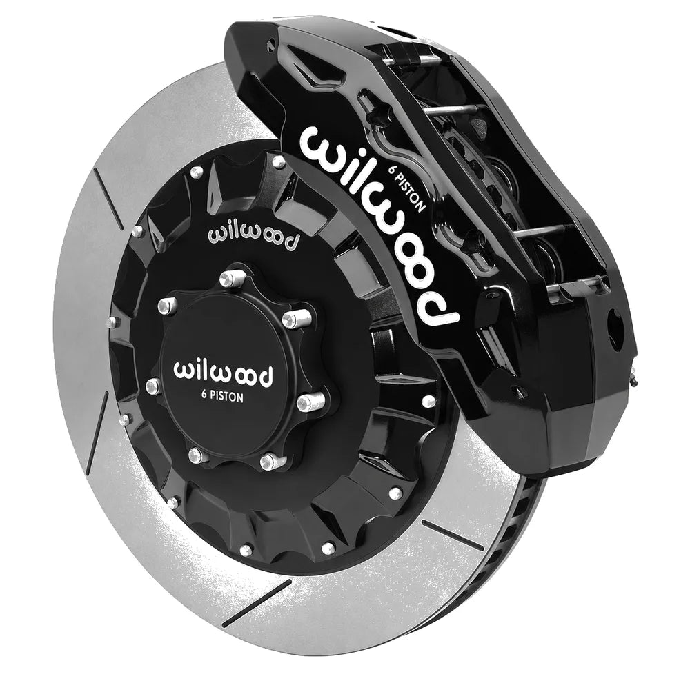 Wilwood TX6R six piston black powder coated front caliper mounted on a sixteen inch two piece slotted rotor with aluminum hat for the Ram 1500 four wheel drive