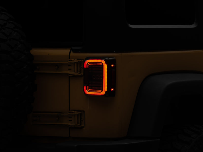 Raxiom 07-18 Jeep Wrangler JK Axial Series LED Halo Tail Lights- Black Housing (Dark Smoked Lens) Raxiom