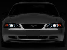 Load image into Gallery viewer, Raxiom 99-04 Ford Mustang Dual LED Halo Projector Headlights- Black Housing (Smoked Lens) - Raxiom 49113